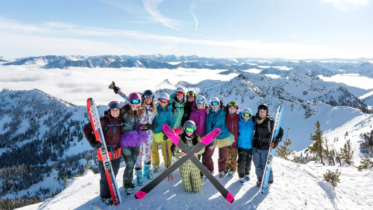 Group of People with Ski Gear at Top of Mountain