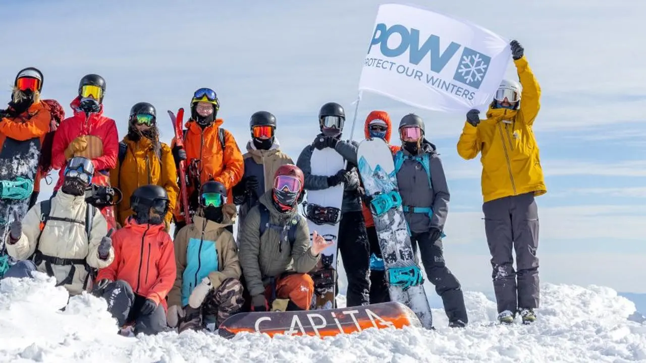 POW skiers and boards on top of mountain