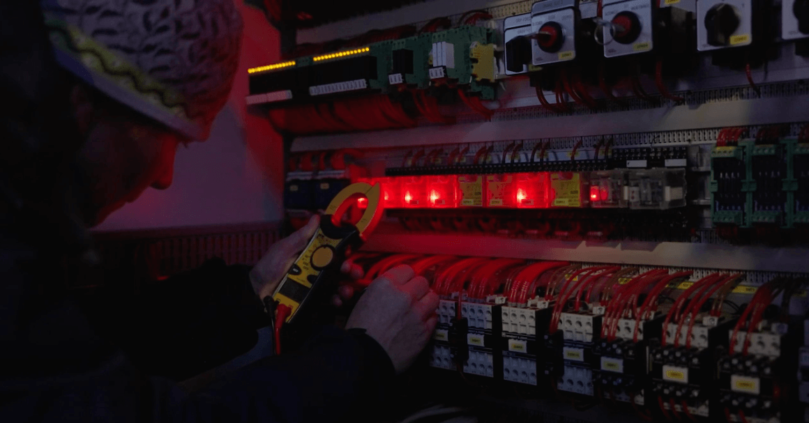 Person working at a light switchboard